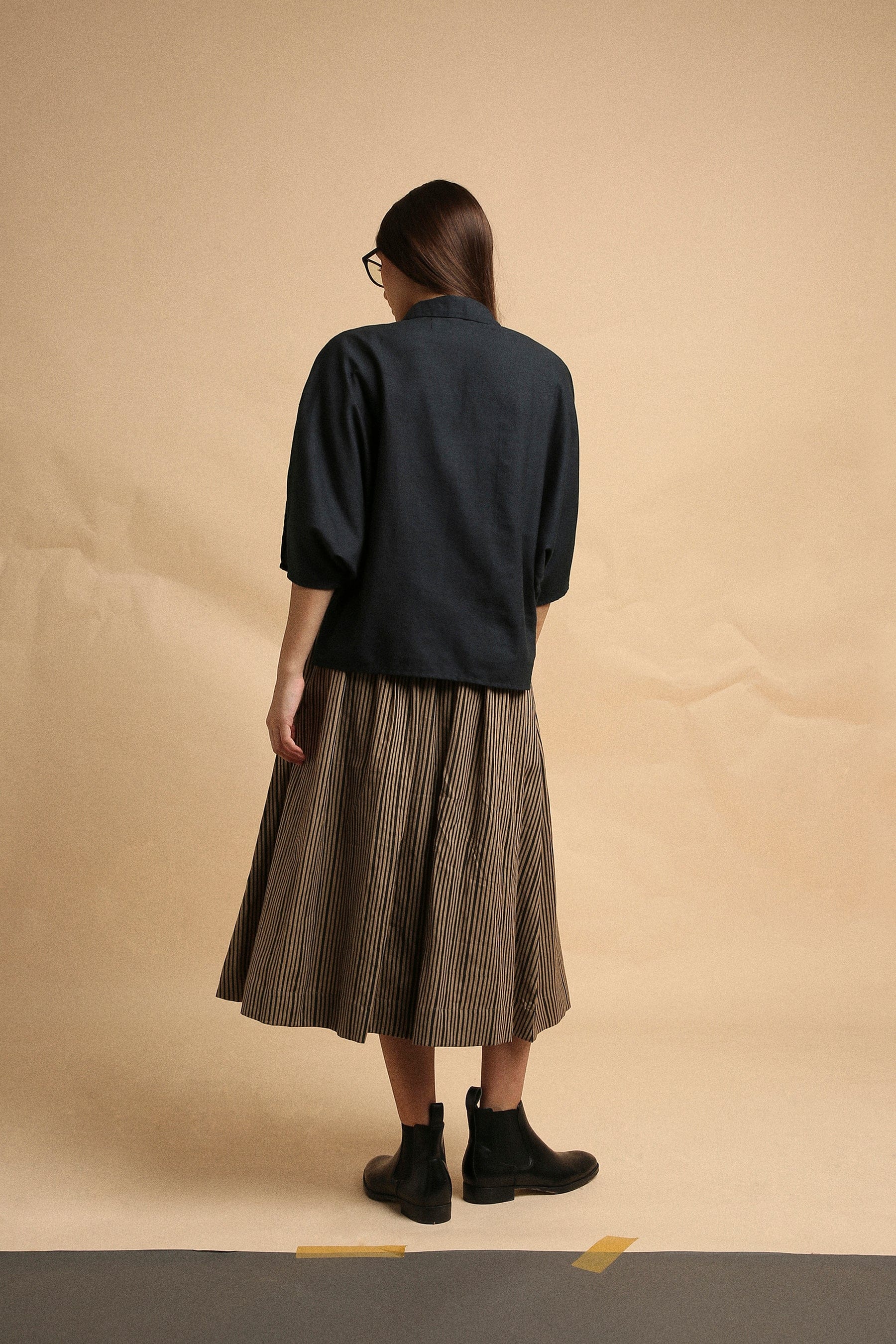 Handspun cotton block print anti-fit collar crop top in charcoal with brown box pleat skirt and side pockets, by MATI India