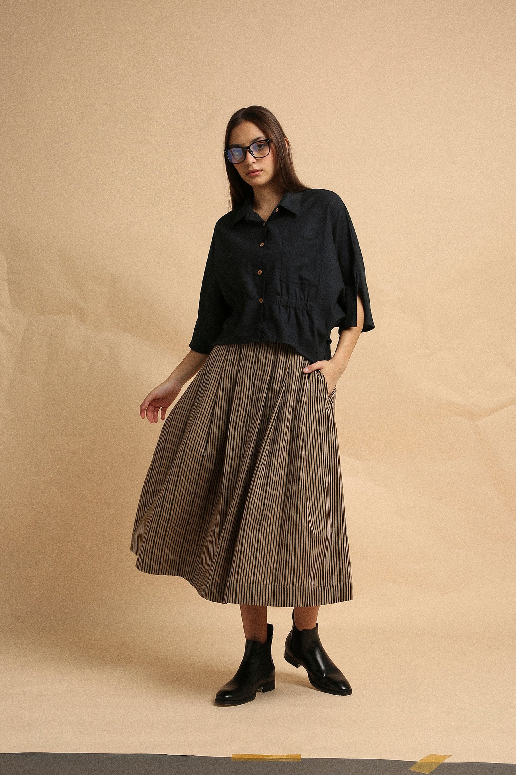 Handspun cotton block print anti-fit collar crop top in charcoal with brown box pleat skirt and side pockets, by MATI India