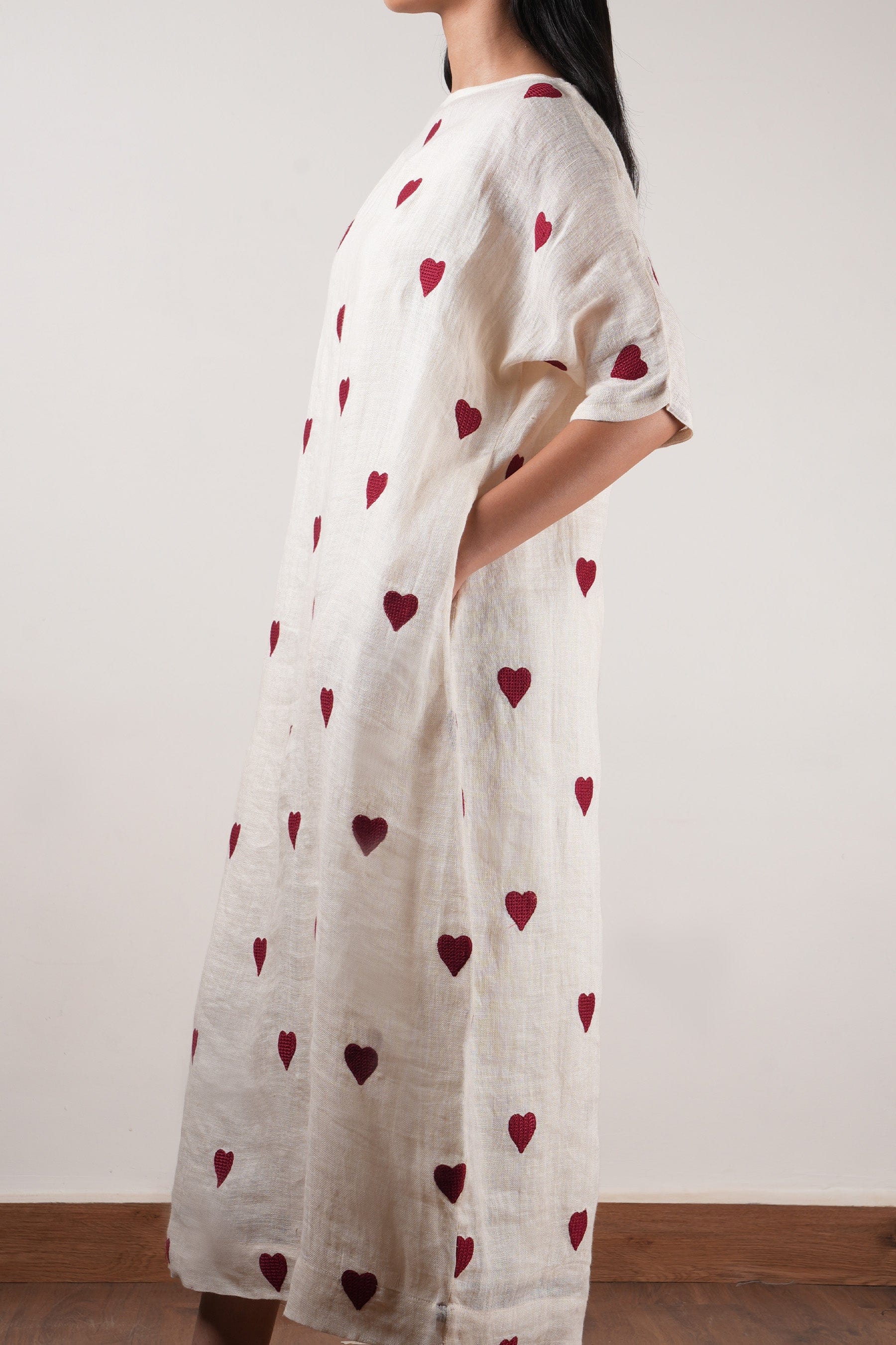 Handwoven linen shift dress in oatmeal with heart thread embroidery and extended sleeves, by MATI India