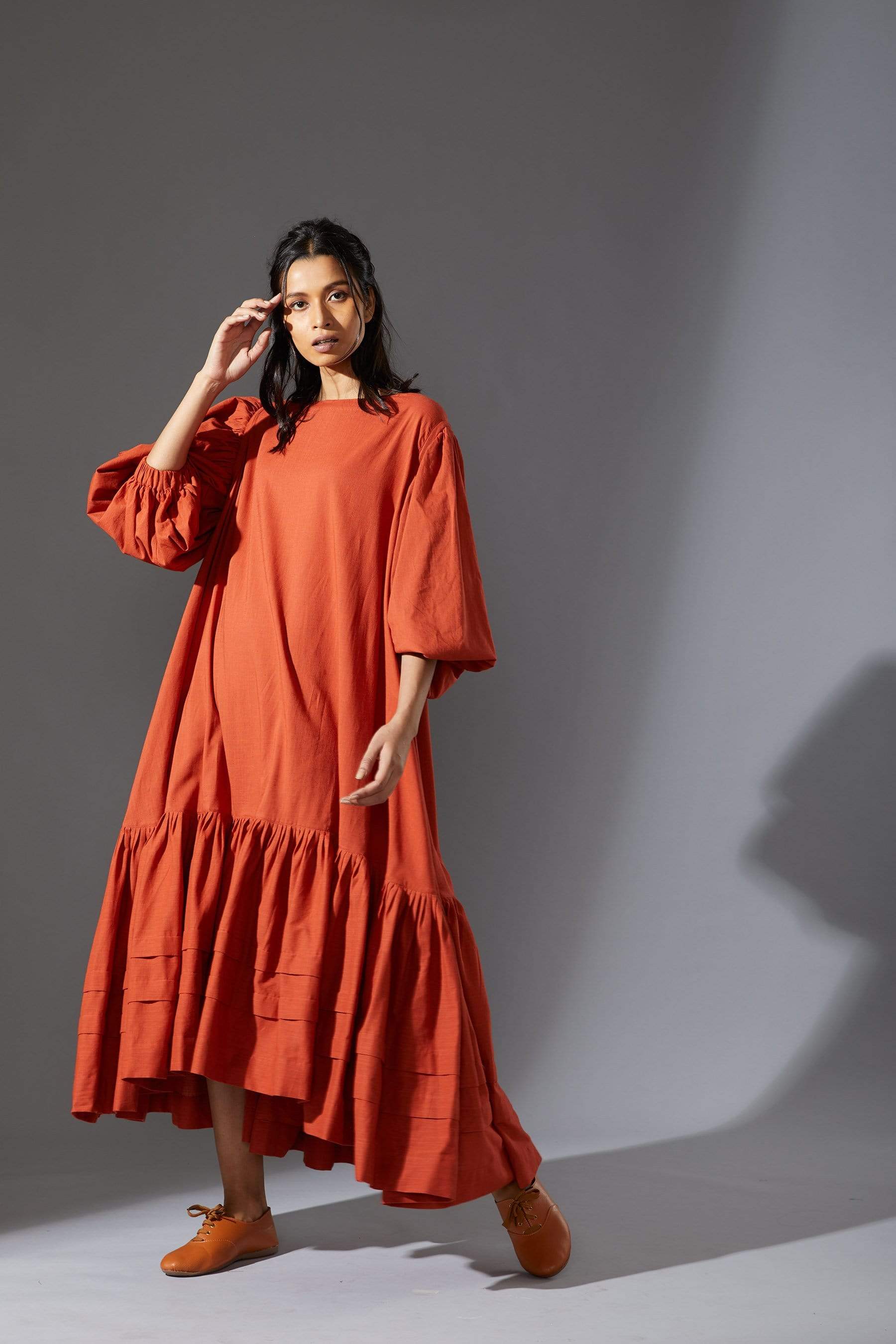 MATI's Kaavya — handwoven cotton slub dress in rust. Blouson sleeves, asymmetric hem, loose fit. Size inclusive XS–7XL. Made-on-order. Wear slow, wear MATI