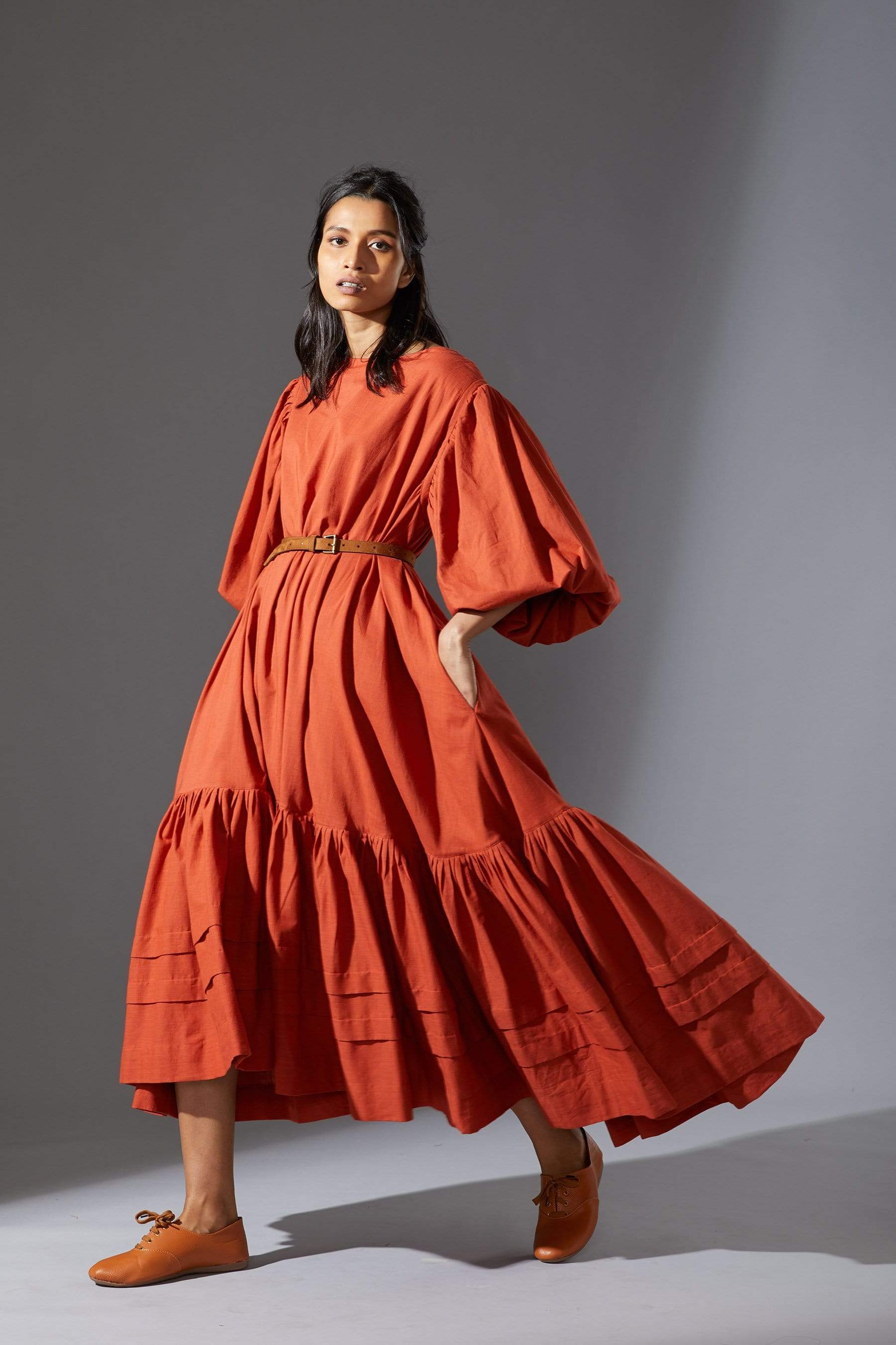 MATI's Kaavya — handwoven cotton slub dress in rust. Blouson sleeves, asymmetric hem, loose fit. Size inclusive XS–7XL. Made-on-order. Wear slow, wear MATI
