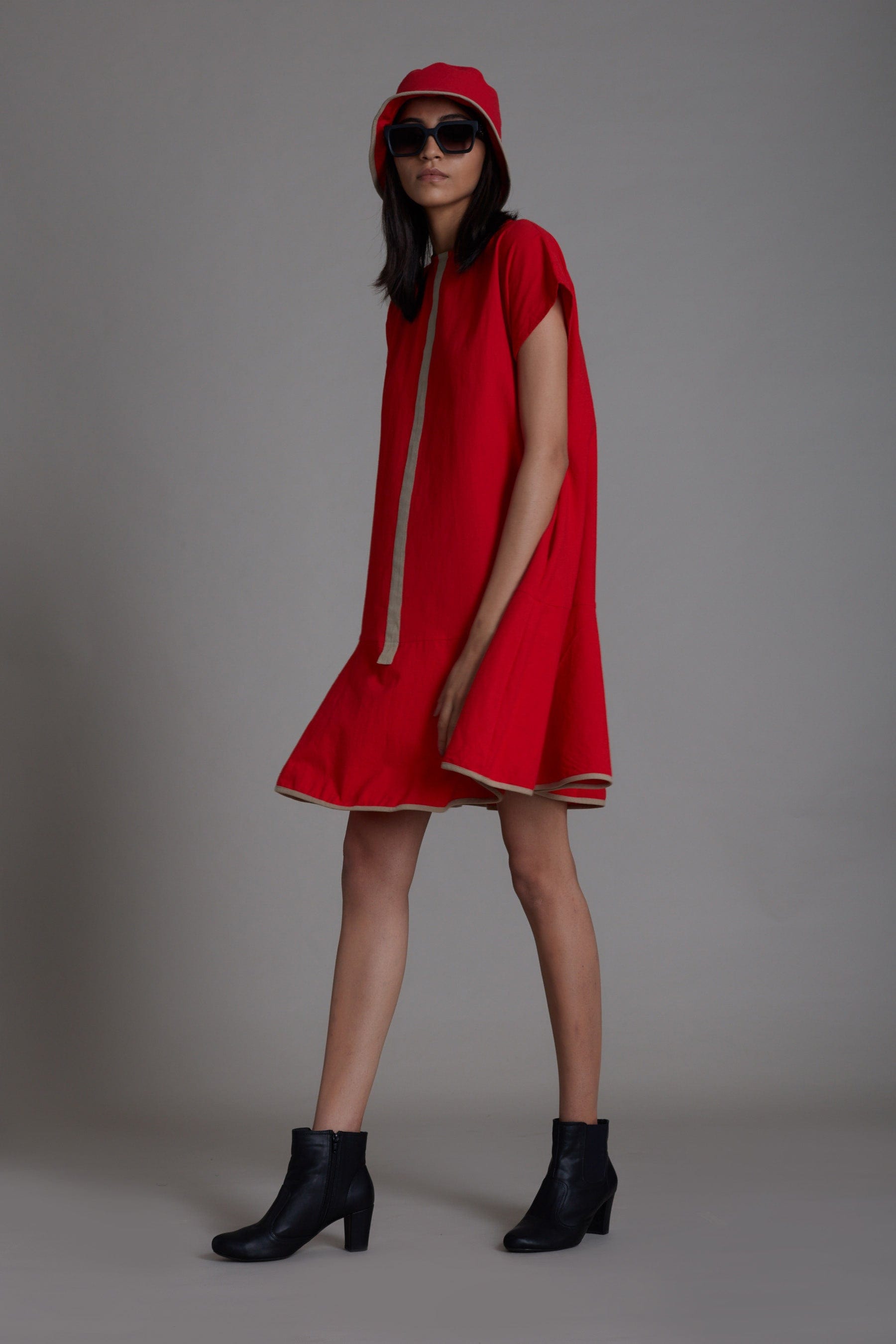 Handwoven cotton A-line dress in red with flared hem, contrast piping and side pockets, by MATI India
