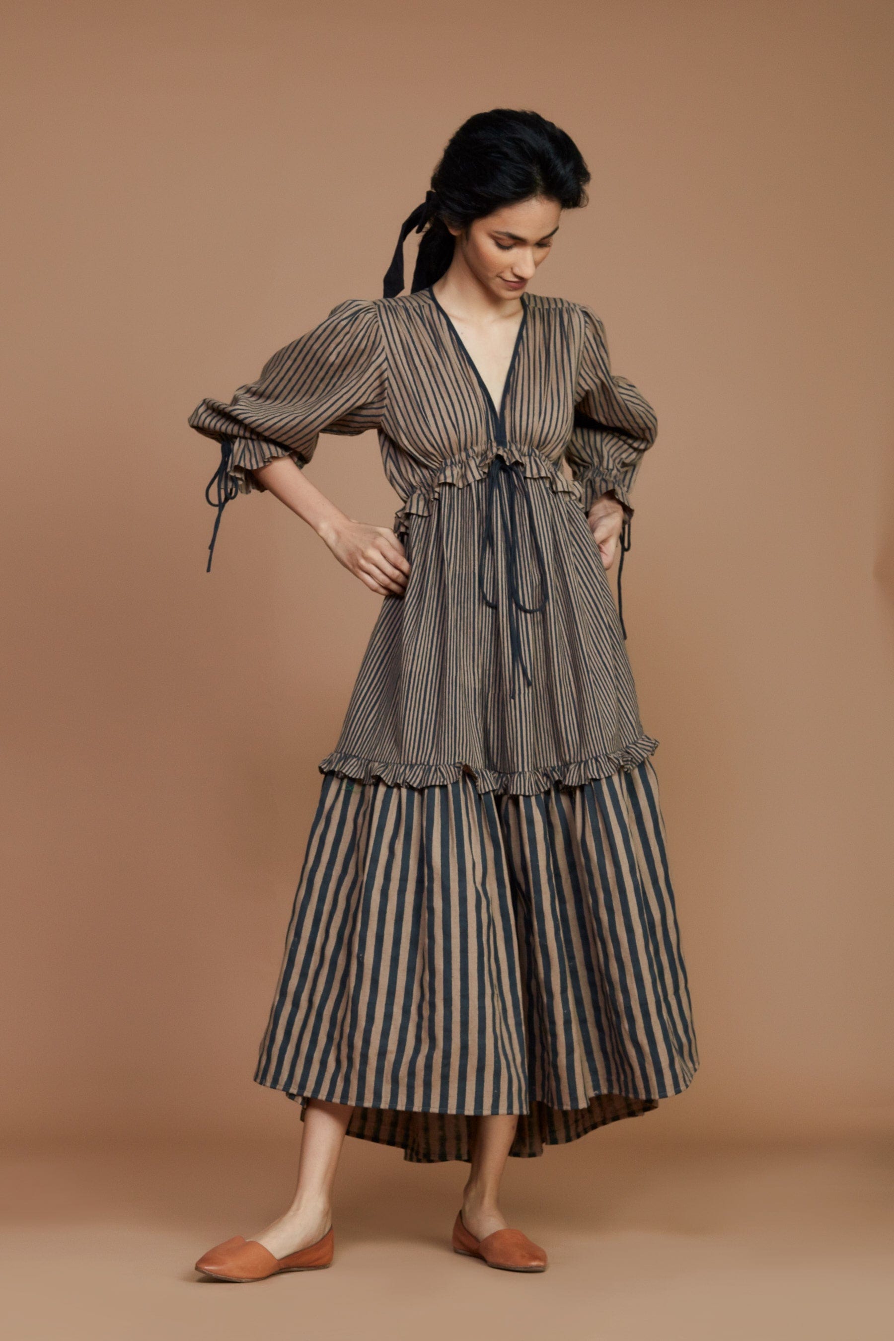 Handwoven cotton striped tiered frill dress in brown with charcoal stripes, Azo-free dye, blouson sleeves and drawstring waist, by MATI India