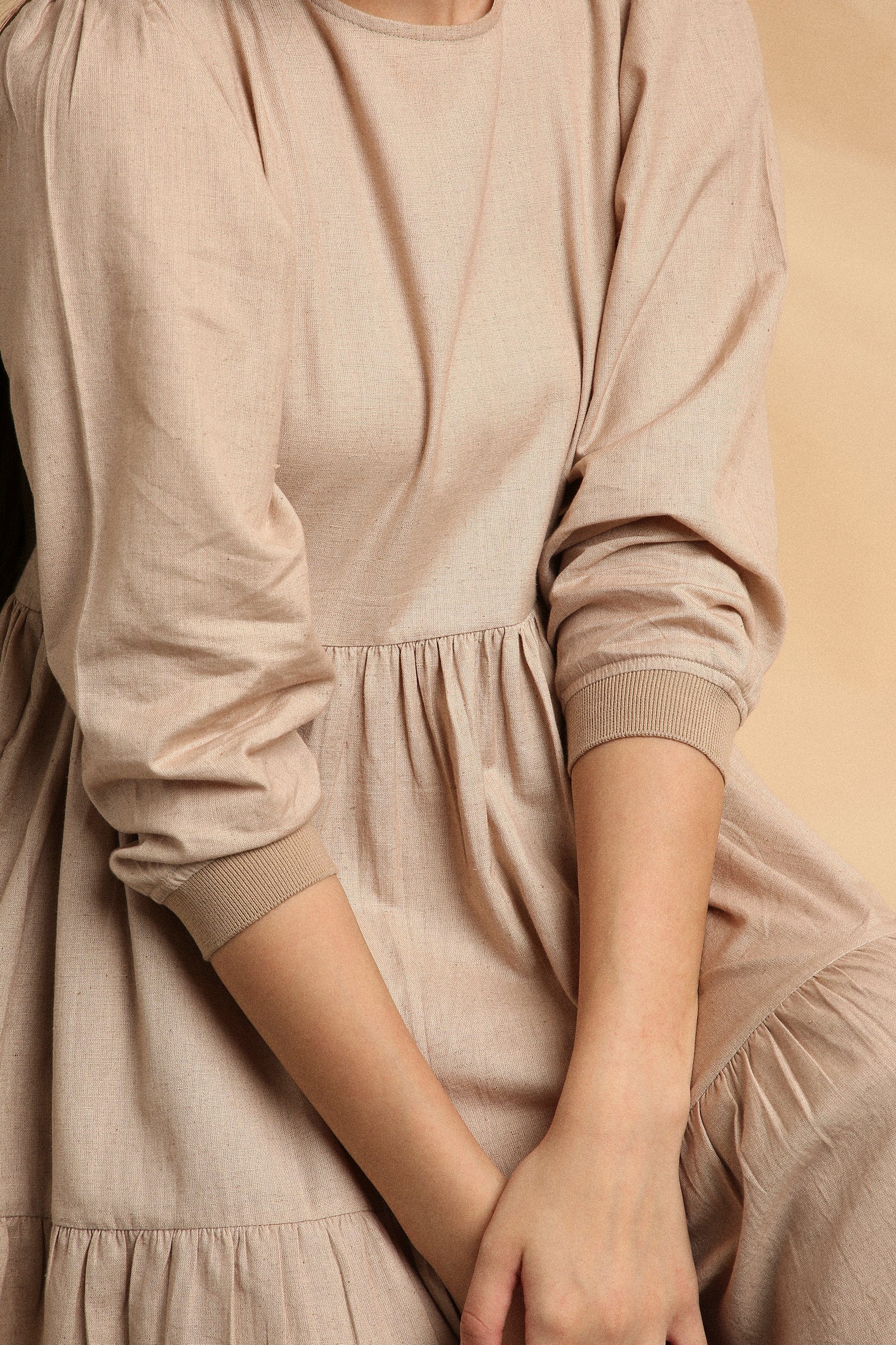 Handspun cotton tiered Vasara rib dress in sand with side pockets and wooden button opening, by MATI India