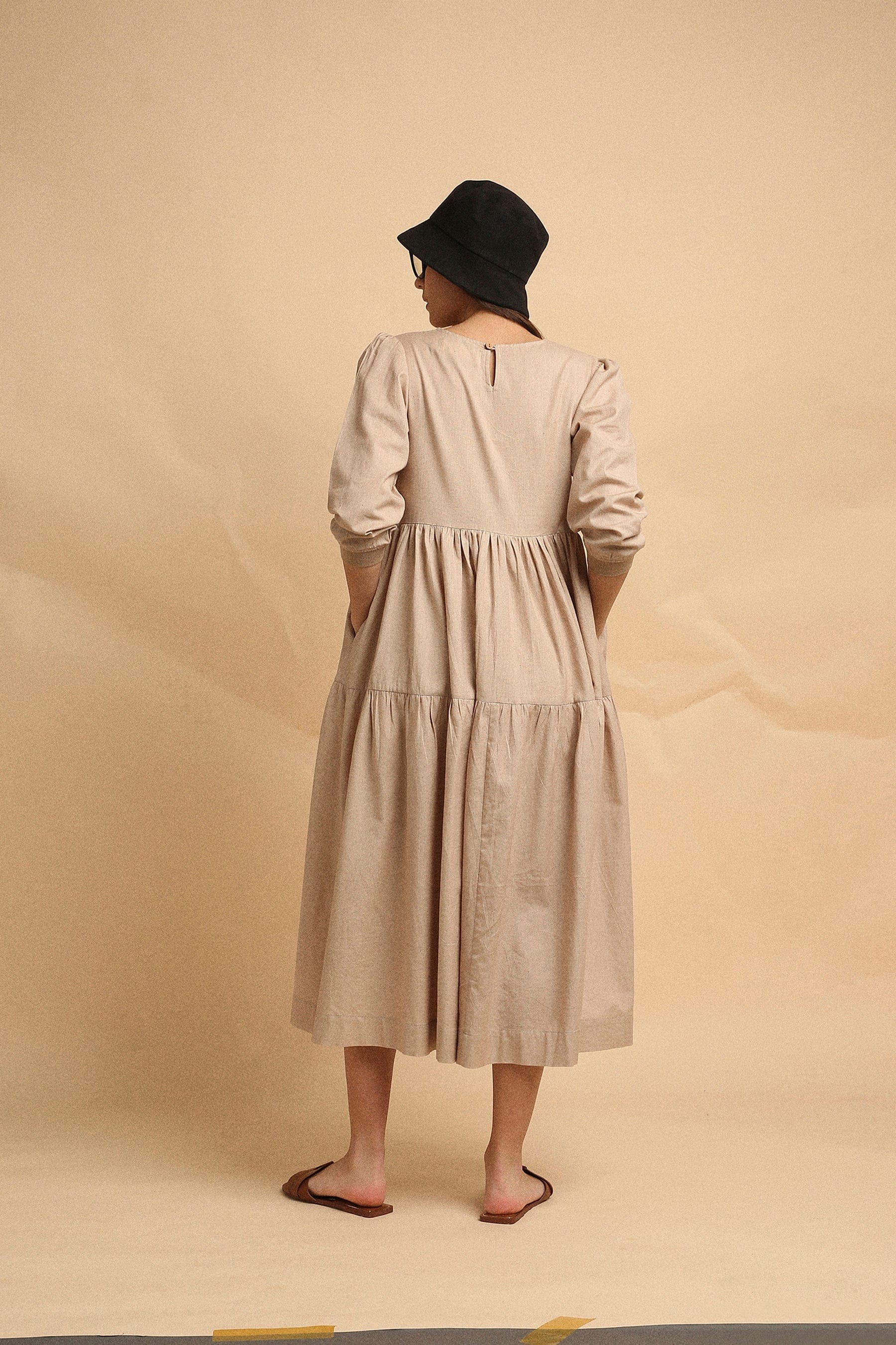 Handspun cotton tiered Vasara rib dress in sand with side pockets and wooden button opening, by MATI India