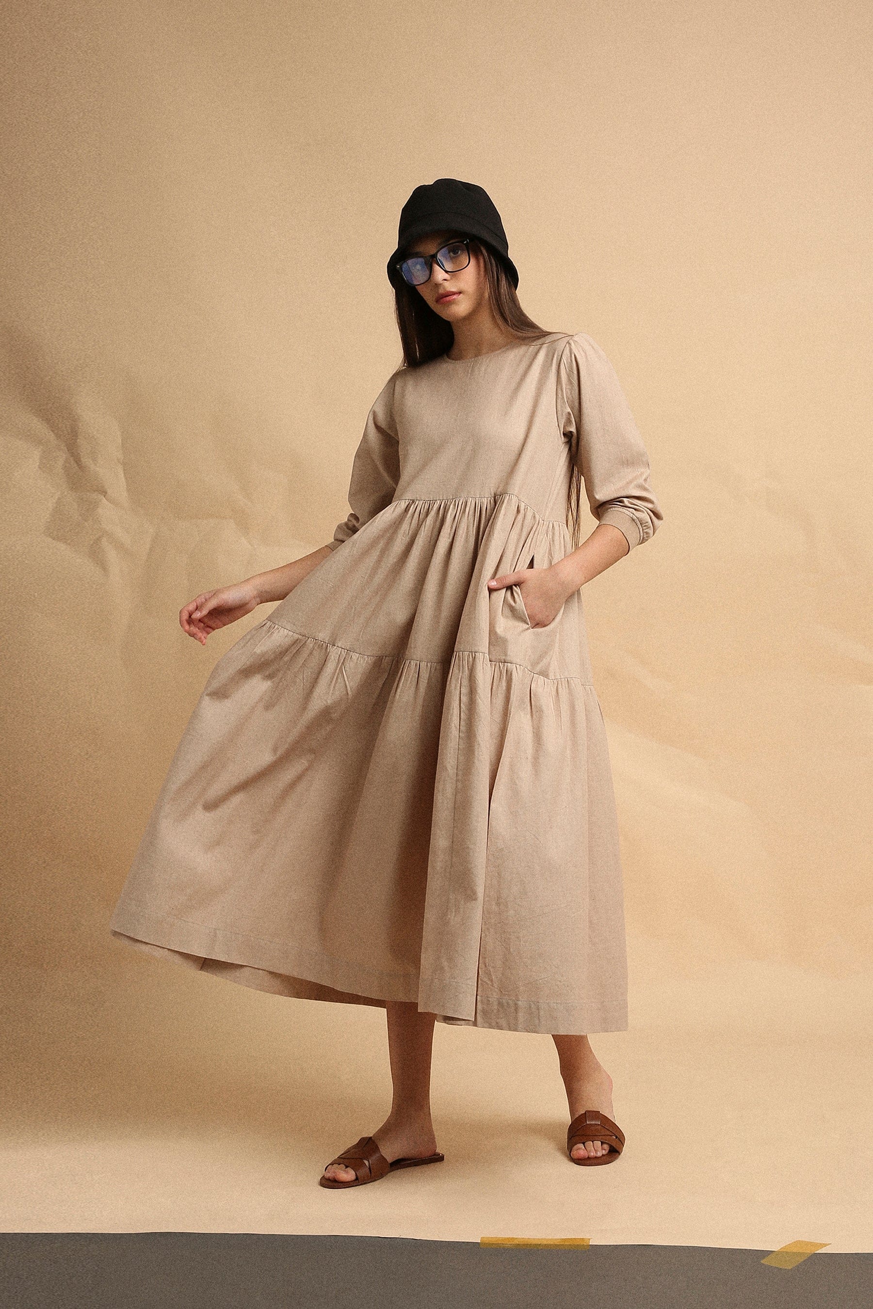 Handspun cotton tiered Vasara rib dress in sand with side pockets and wooden button opening, by MATI India