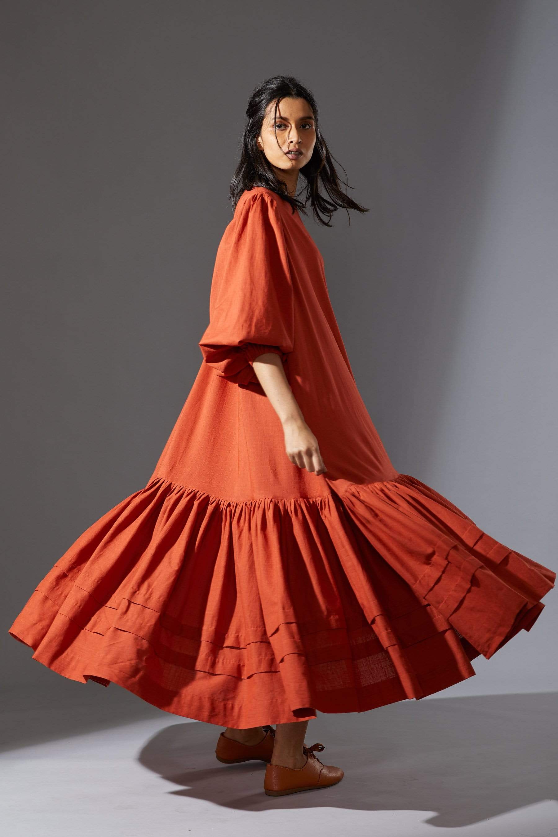 MATI's Kaavya — handwoven cotton slub dress in rust. Blouson sleeves, asymmetric hem, loose fit. Size inclusive XS–7XL. Made-on-order. Wear slow, wear MATI