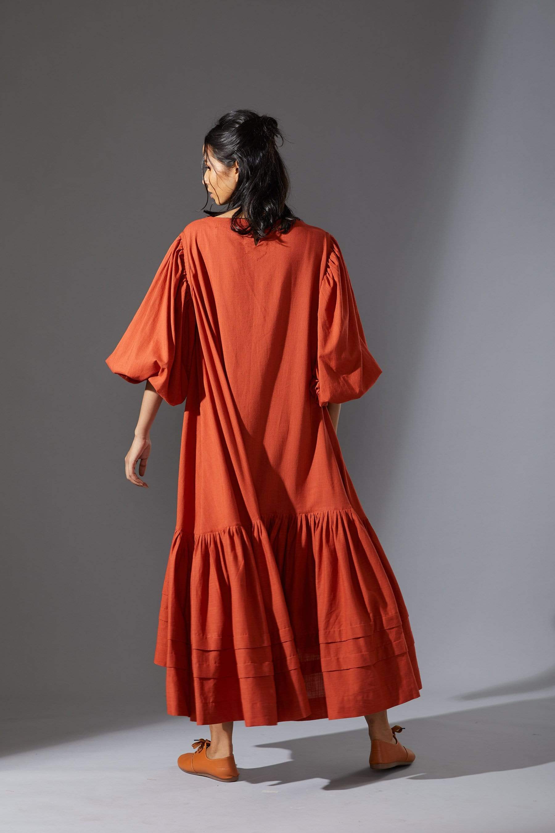 MATI's Kaavya — handwoven cotton slub dress in rust. Blouson sleeves, asymmetric hem, loose fit. Size inclusive XS–7XL. Made-on-order. Wear slow, wear MATI