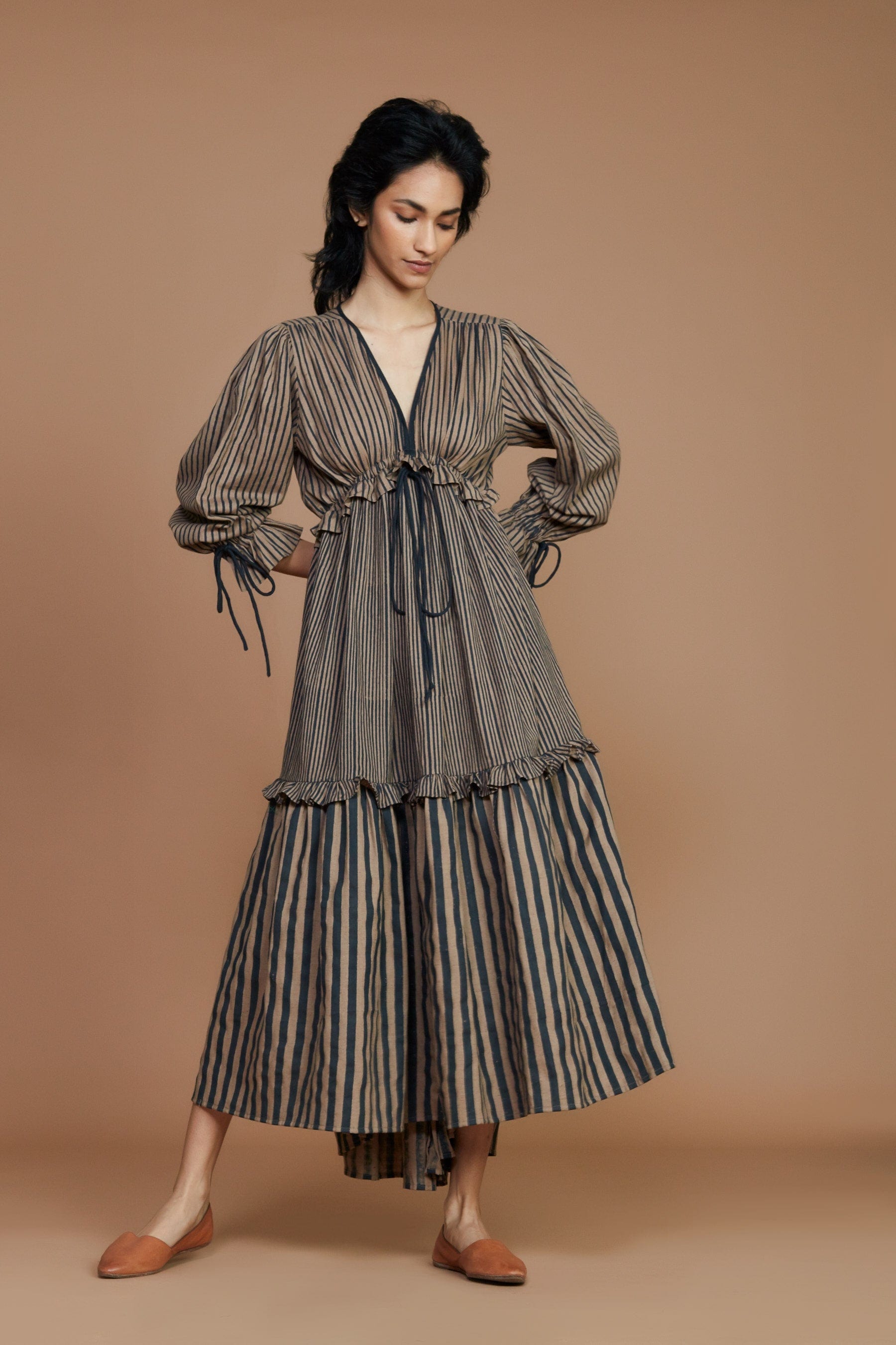 Handwoven cotton striped tiered frill dress in brown with charcoal stripes, Azo-free dye, blouson sleeves and drawstring waist, by MATI India