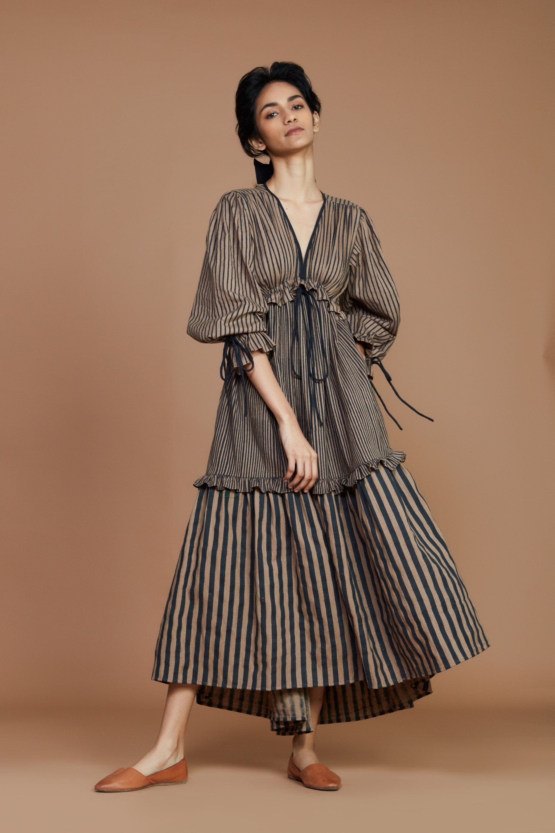 Handwoven cotton striped tiered frill dress in brown with charcoal stripes, Azo-free dye, blouson sleeves and drawstring waist, by MATI India