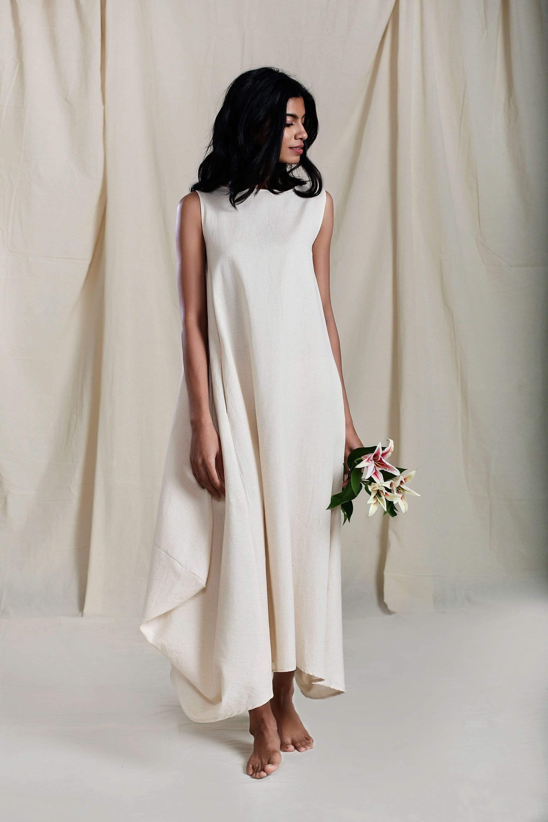 Handwoven cotton side cowl dress in oatmeal with boatneck and asymmetric hem, by MATI India